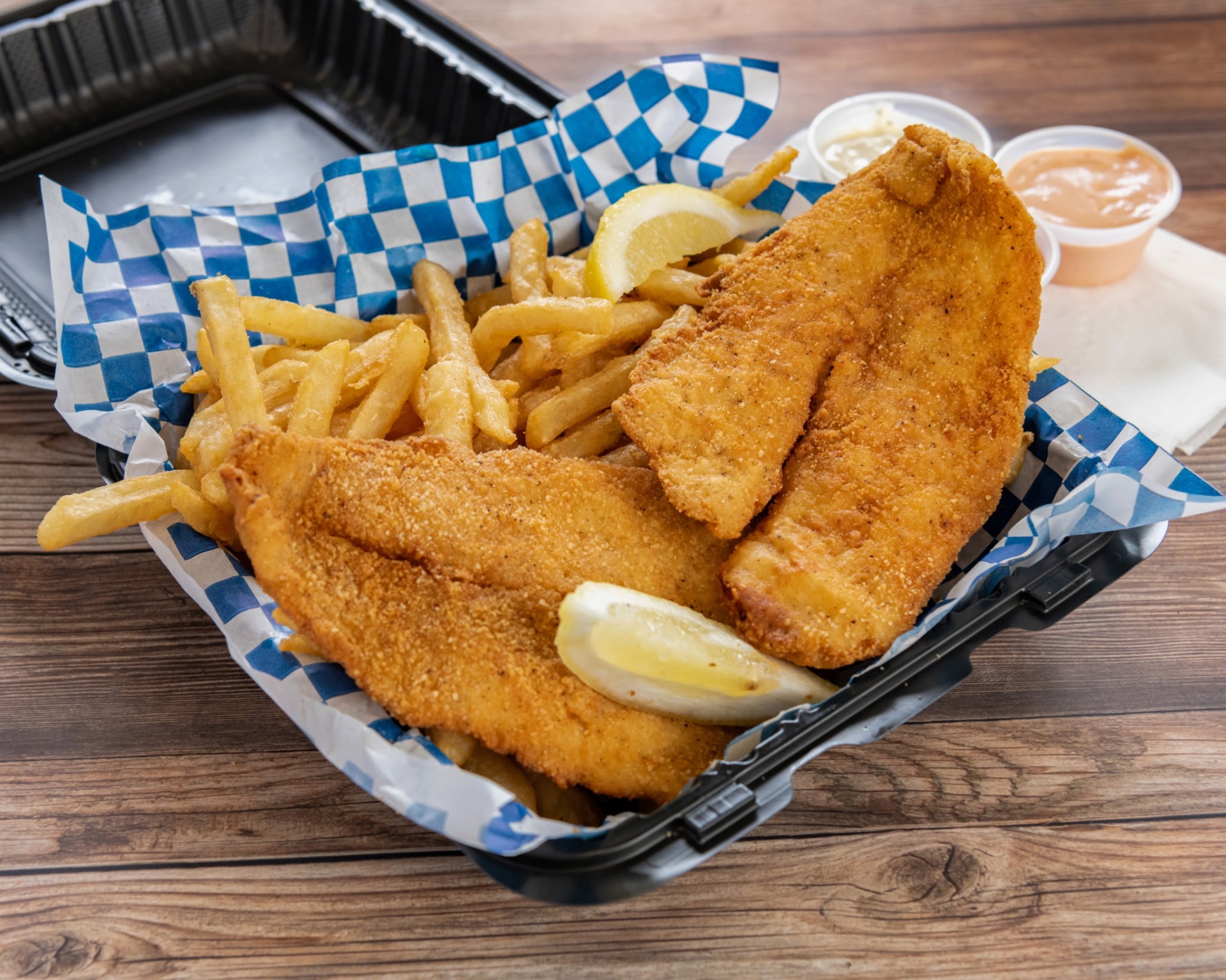 Golden catfish basket with fries and lemon