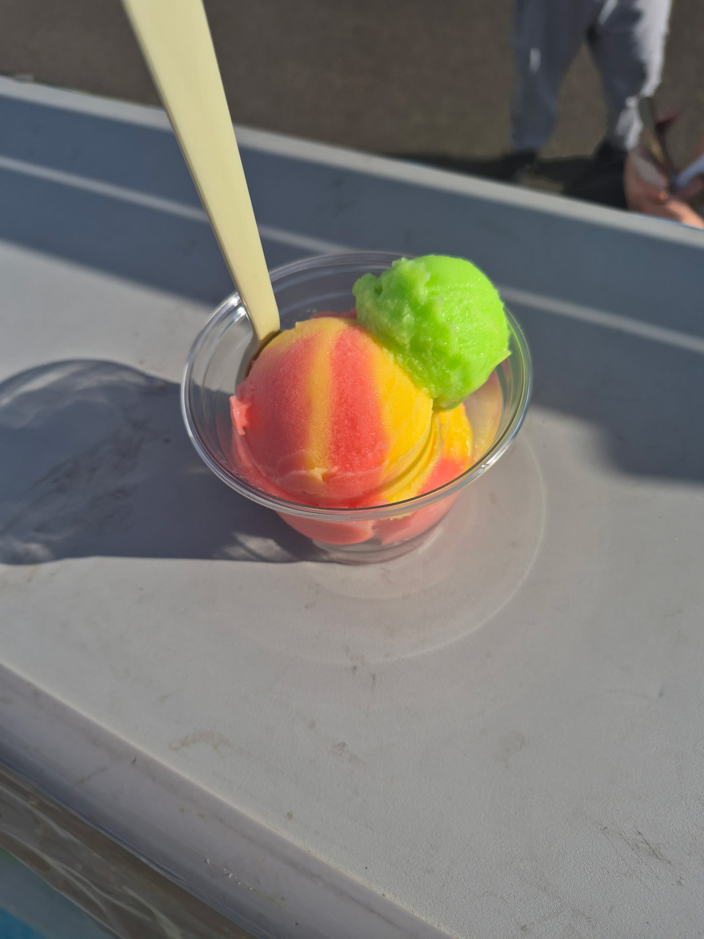 Colorful water ice scoops in a cup